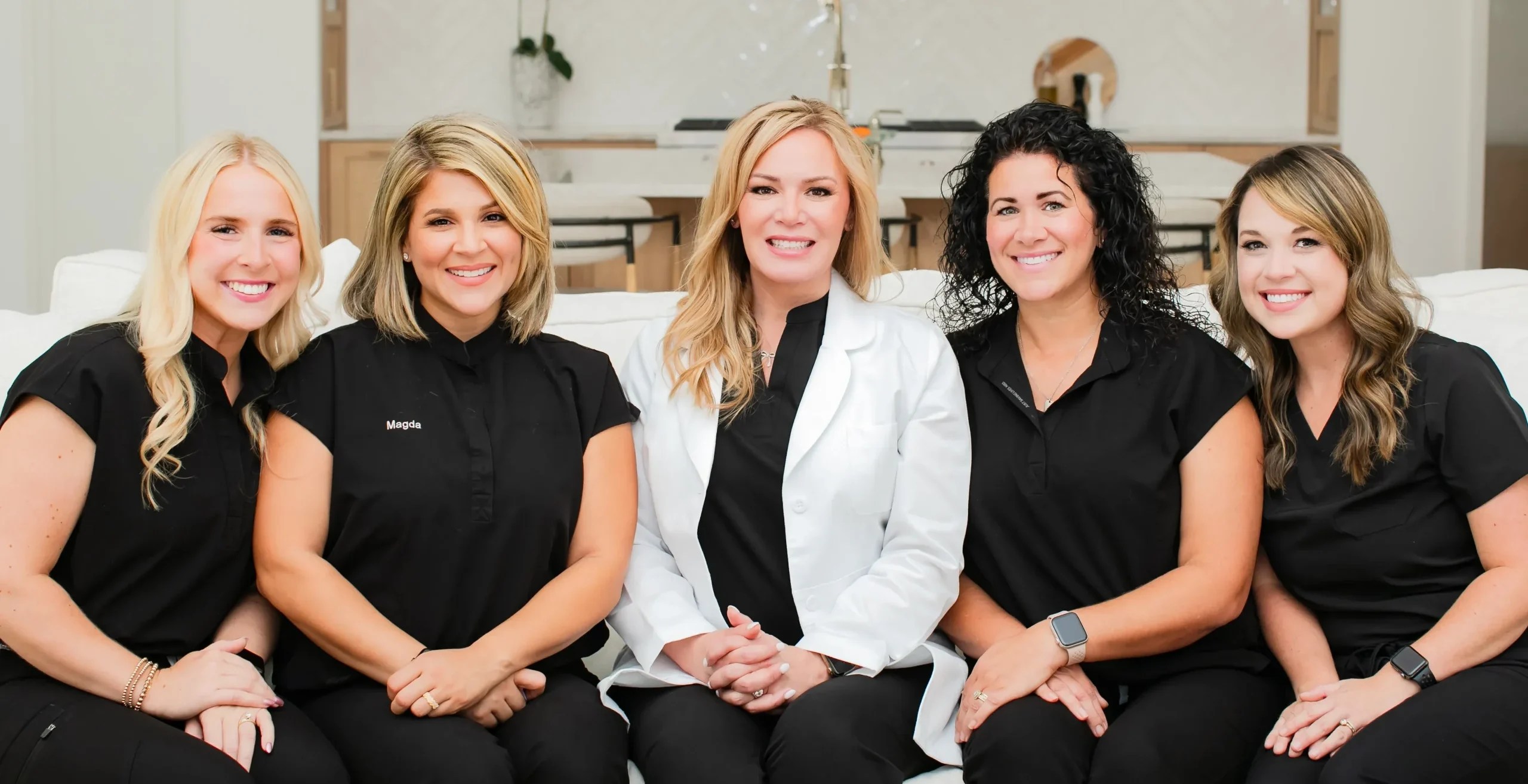 Group of 4 team members and Dentist smiling